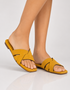 Model wearing Yellow Aira women's cross strap flat sandals with padded comfort sole