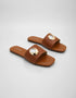 Pair of Aurelle brown flat sandals with statement gold metal ring detail