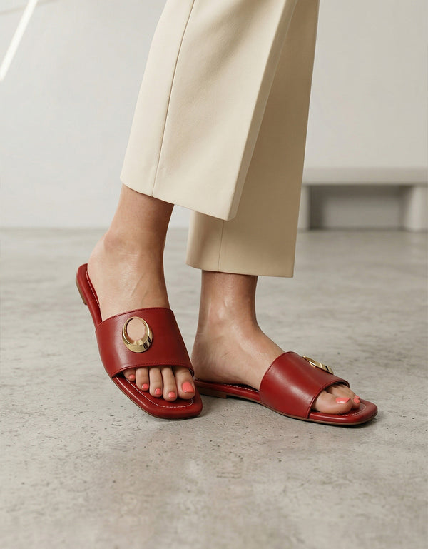 Model wearing Aurelle maroon metal ring flat sandals with soft padded comfort sole