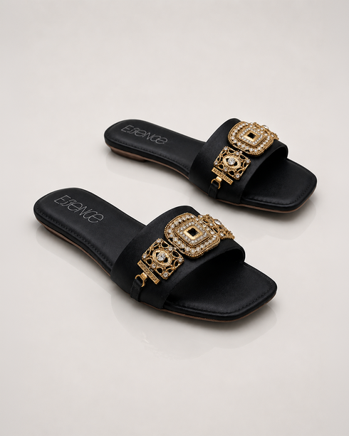 Pair of black embellished flat sandals with antique gold detailing and cushioned comfort.
