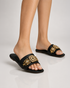 Woman wearing Aurista black embellished flat sandals styled with festive and everyday outfits.