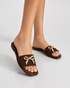 Close up of Aveen brown flat sandals featuring embellished bow detail