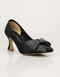 Black party wear heels for women with pointed toe silhouette and crystal bow front view β Essence by Rubina