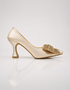 Golden pointed toe pumps for women with decorative crystal bow and elegant low heel