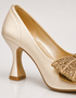 Golden pointed toe party wear heels featuring bow and low heel