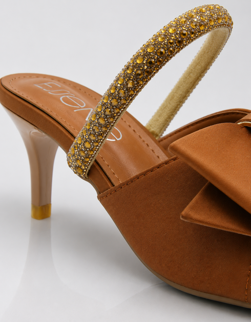 Close up of brown bow sandal showing shimmer strap and premium craftsmanship.