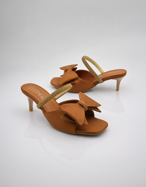 Pair of brown bow kitten heel sandals with elegant shimmer strap and open toe design.