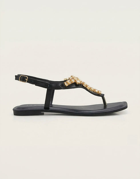 Side view of black flat T-strap sandals with crystal design, elegant women footwear for summer, durable comfortable sandals for daily wear and formal occasions