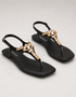 Top view of black womenβs T-strap sandals with crystal accents, minimalist flat sandals for girls, trendy summer footwear Pakistan, comfortable and stylish ladies sandals