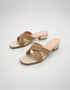 Woman wearing gold embellished low block heel slippers for weddings and festive occasions.