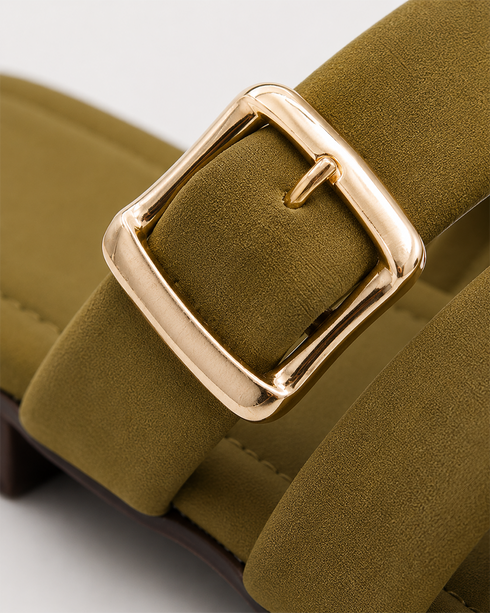 Close up of olive cross strap sandals highlighting the statement buckle and premium craftsmanship.