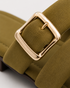 Close up of olive cross strap sandals highlighting the statement buckle and premium craftsmanship.