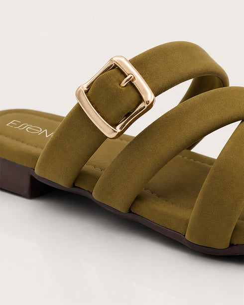 Close up of olive cross strap sandals highlighting the statement buckle and premium craftsmanship.