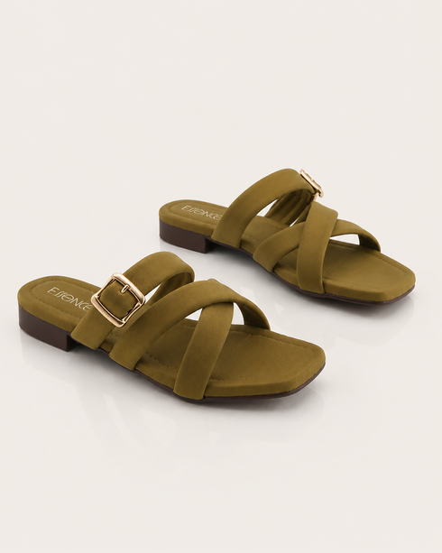 Pair of olive cross strap flat sandals with statement buckle and soft padded sole.