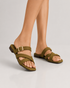 Woman wearing olive cross strap flat sandals styled with everyday casual outfits.