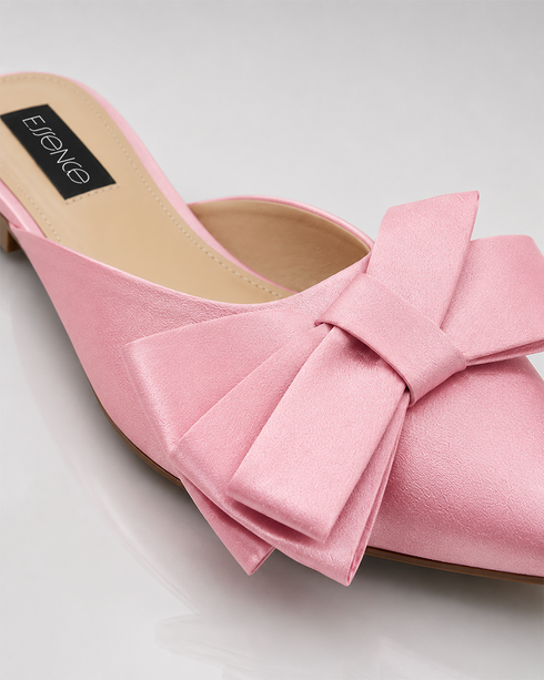 Detailed view of oversized bow on pink pointed toe flat mules