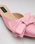 Detailed view of oversized bow on pink pointed toe flat mules
