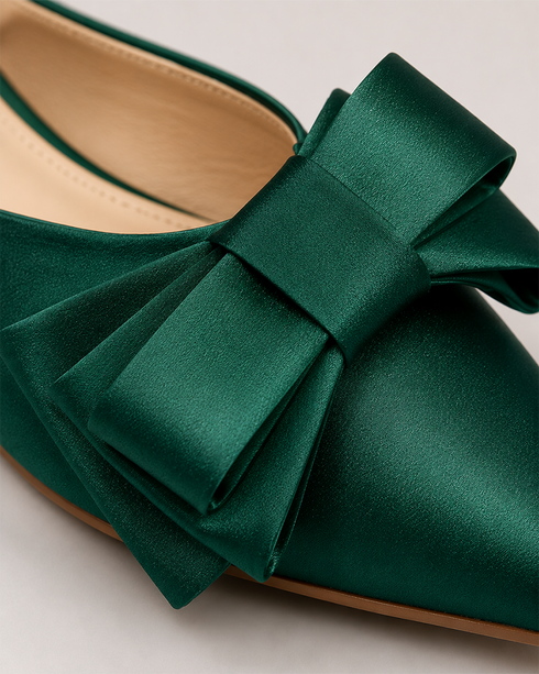 Close up of handcrafted bow detail on pink pointed toe flat mules