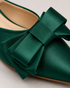 Close up of handcrafted bow detail on pink pointed toe flat mules