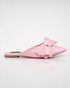 Side view of pink pointed toe flat mules with statement bow