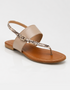 Beige flat sandals for women featuring a snake textured strap and soft padded sole
