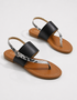 Pair of Black flat sandals with textured strap detailing