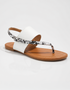 White flat sandals for women with textured strap and open toe design