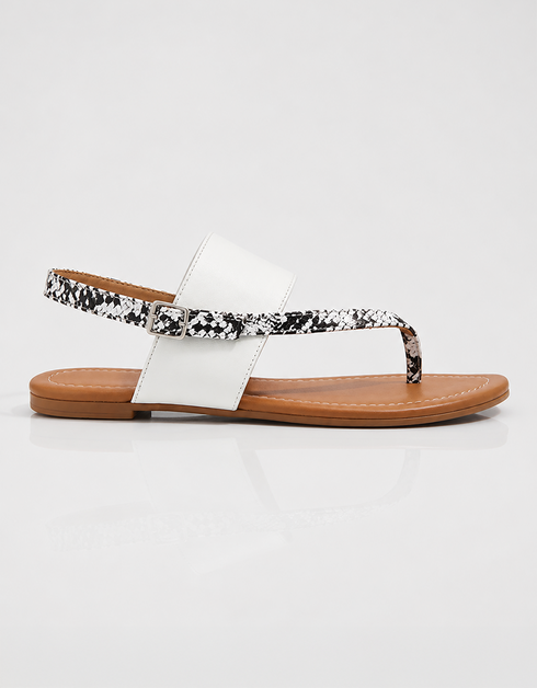 Side profile of white flat sandals with slip on design