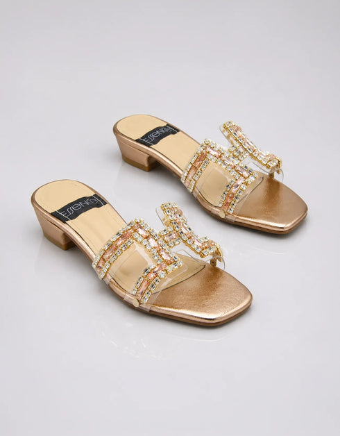 Pair of Gilda luxury gold block heels with embellished straps, statement stone buckles, and premium synthetic construction