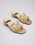 Pair of Gilda luxury gold block heels with embellished straps, statement stone buckles, and premium synthetic construction