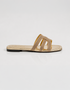 Side view of gold shimmer flat sandals featuring a lightweight slip on design and sleek multi straps.