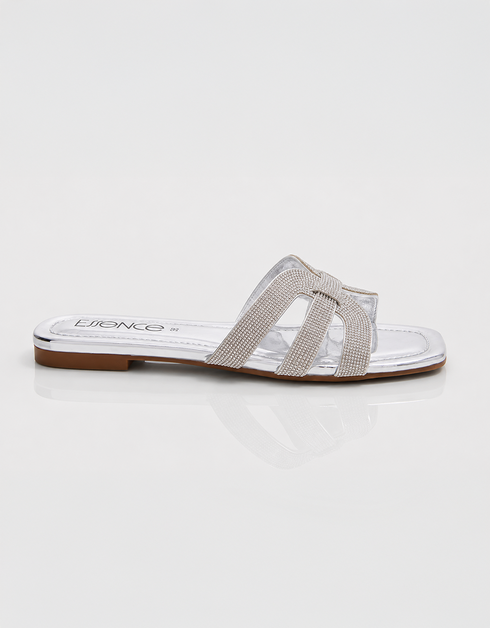 Side view of silver shimmer flat sandals featuring lightweight slip on construction.
