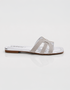 Side view of silver shimmer flat sandals featuring lightweight slip on construction.