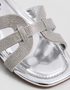 Close up of silver shimmer flat sandals showcasing the premium textured multi strap finish.