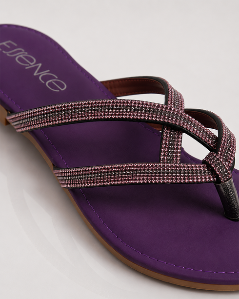 Close-up of shimmering straps on purple flat sandals