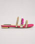 Side view of pink triple strap sandals with stone embellishments