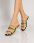 Woman wearing green embellished flat sandals for festive styling