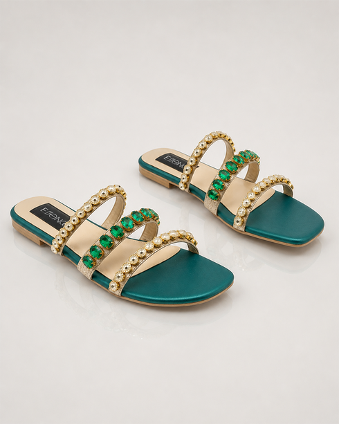 Close-up of crystal stones on embellished triple strap sandals