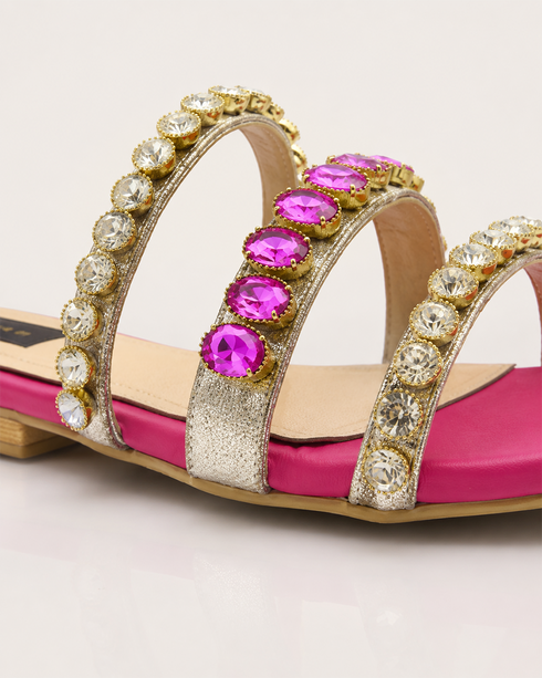 Close-up of crystal stones on embellished triple strap sandals