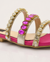 Close-up of crystal stones on embellished triple strap sandals