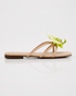 Side view of beige floral flat sandals featuring an orchid flower accent and lightweight slip on design.