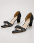 Pair of black transparent block heel sandals with embellished crossover straps and padded comfort.