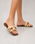 Model wearing beige buckle flat sandals styled with casual everyday outfits.