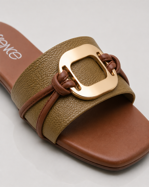 Close up of olive green buckle flat sandals showing textured strap and premium metallic buckle.