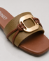 Close up of olive green buckle flat sandals showing textured strap and premium metallic buckle.