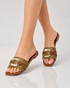 Model wearing olive green buckle flat sandals with soft padded comfort sole.