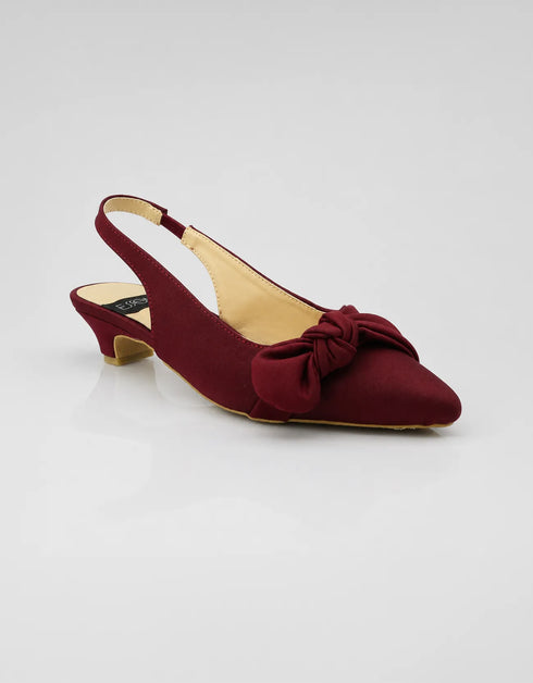 Front view of Marcelle burgundy bow slingback pumps featuring a pointed toe, statement bow, premium textile fabric, and soft padded insole.