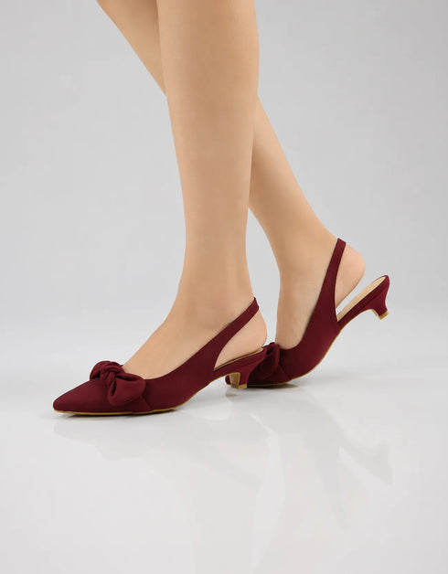 Model wearing Marcelle burgundy bow slingback pumps styled for office wear, parties, and special occasions.