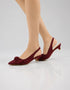 Model wearing Marcelle burgundy bow slingback pumps styled for office wear, parties, and special occasions.