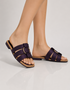 Woman wearing purple multi strap flat sandals styled with everyday summer outfits.